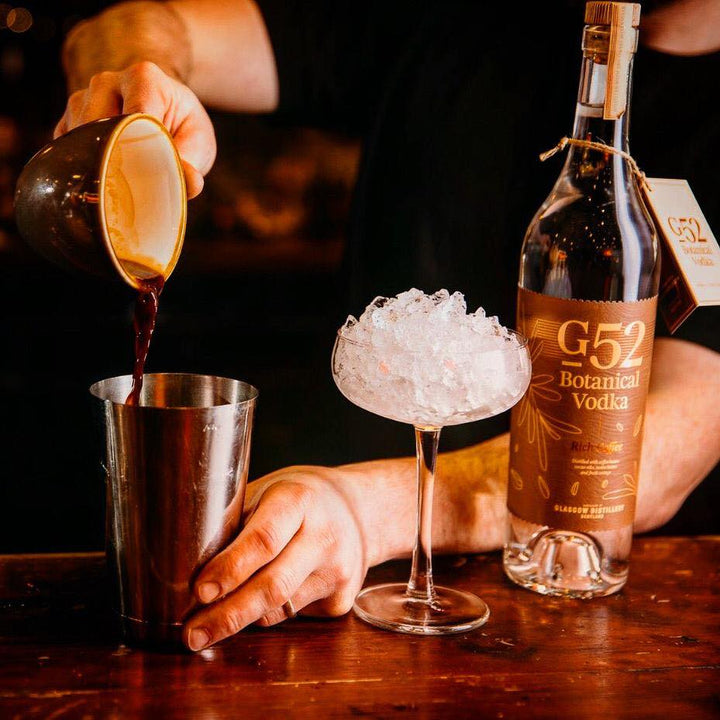 G52 Rich Coffee Botanical Vodka bottle beside a cocktail being prepared