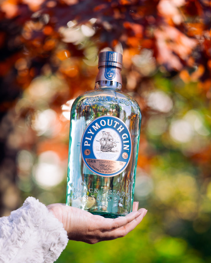 Plymouth Gin bottle held outdoors